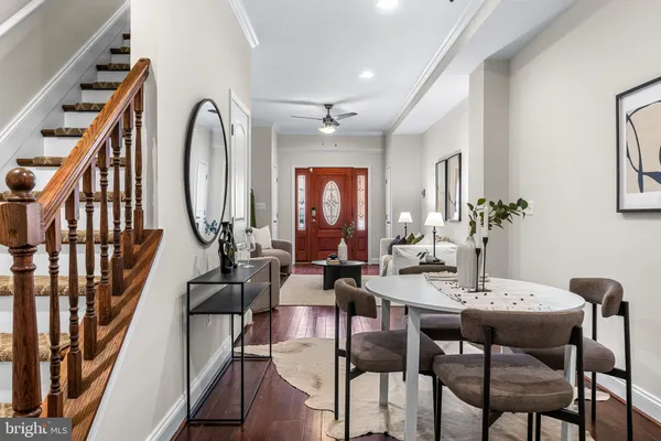 a view of a dining room with furniture chandelier and wooden floor