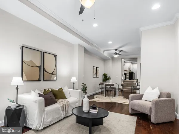 a living room with couches a mirror and a table