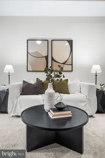 a living room with couches a mirror and a table