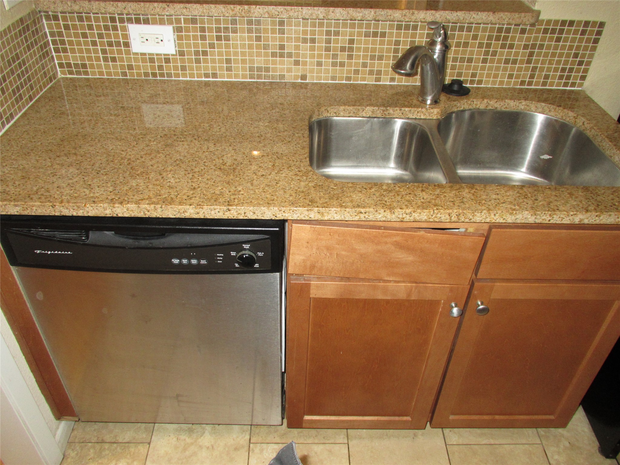 3204 Menchaca Road, Unit 702 Austin, TX 78704 - Photo 8 of 14 Kitchen with dishwasher, backsplash, wood finish cabinets, and light stone countertops