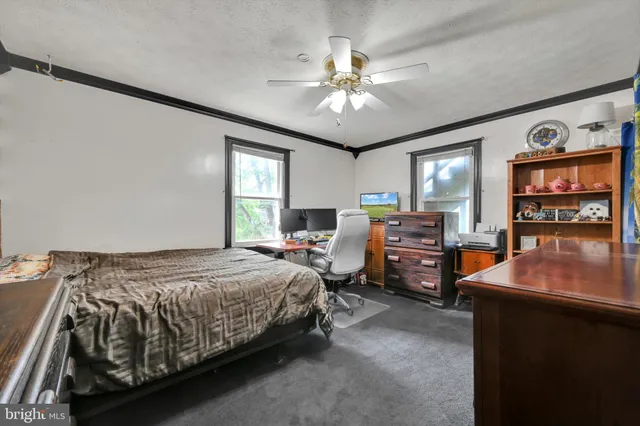 a bedroom with bed and window