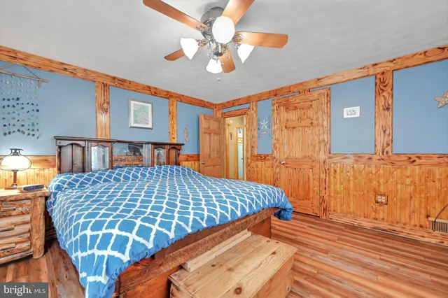 a bedroom with a large bed and a chandelier