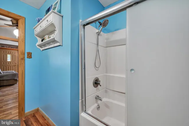a bathroom with a glass shower door
