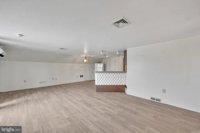 a view of a room with wooden floor and cabinet