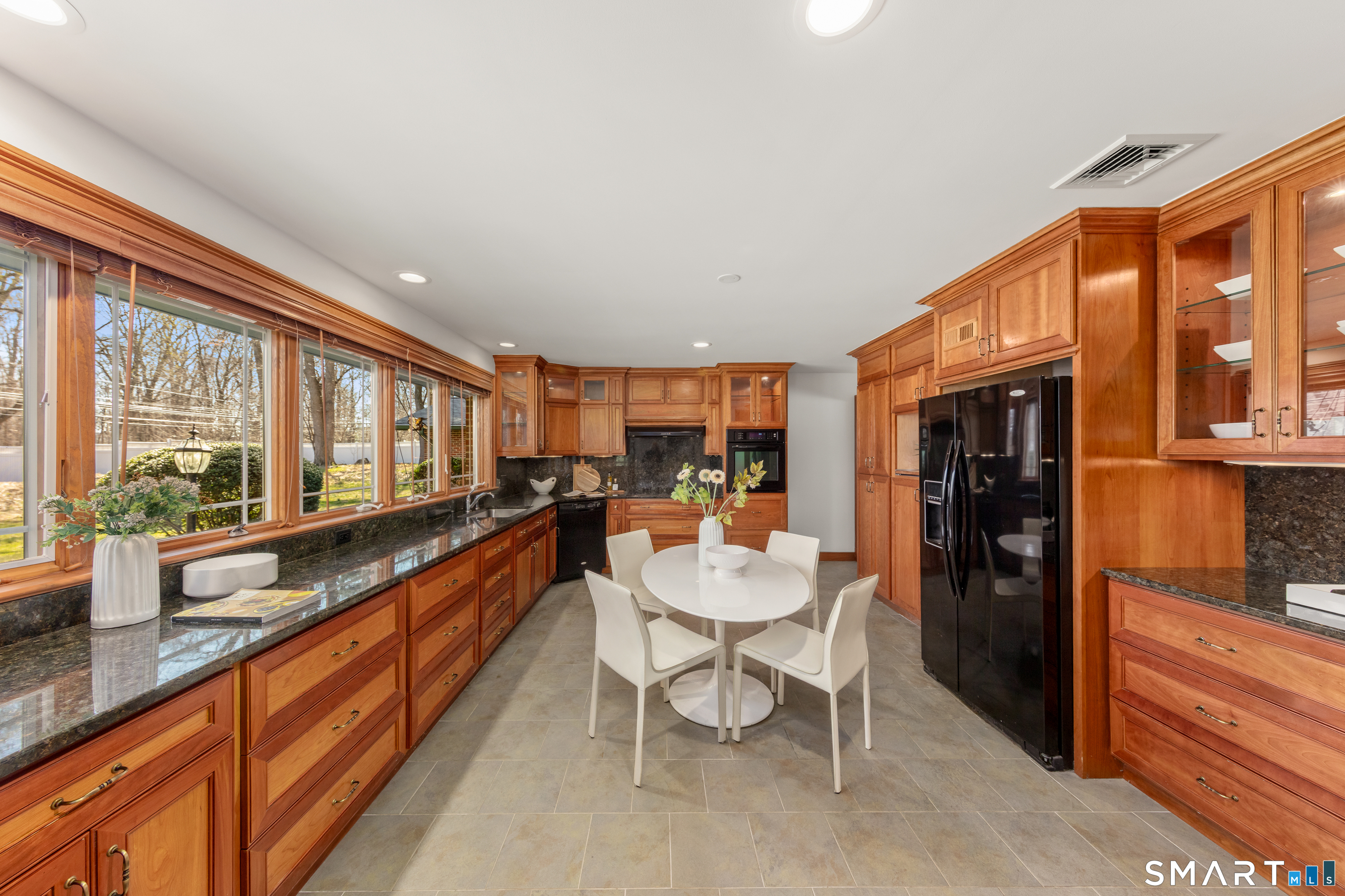 143 Palmer Hill Road Stamford, CT 06902 - Photo 12 of 40 a large living room with stainless steel appliances kitchen island granite countertop a refrigerator a stove and a sink with granite countertops