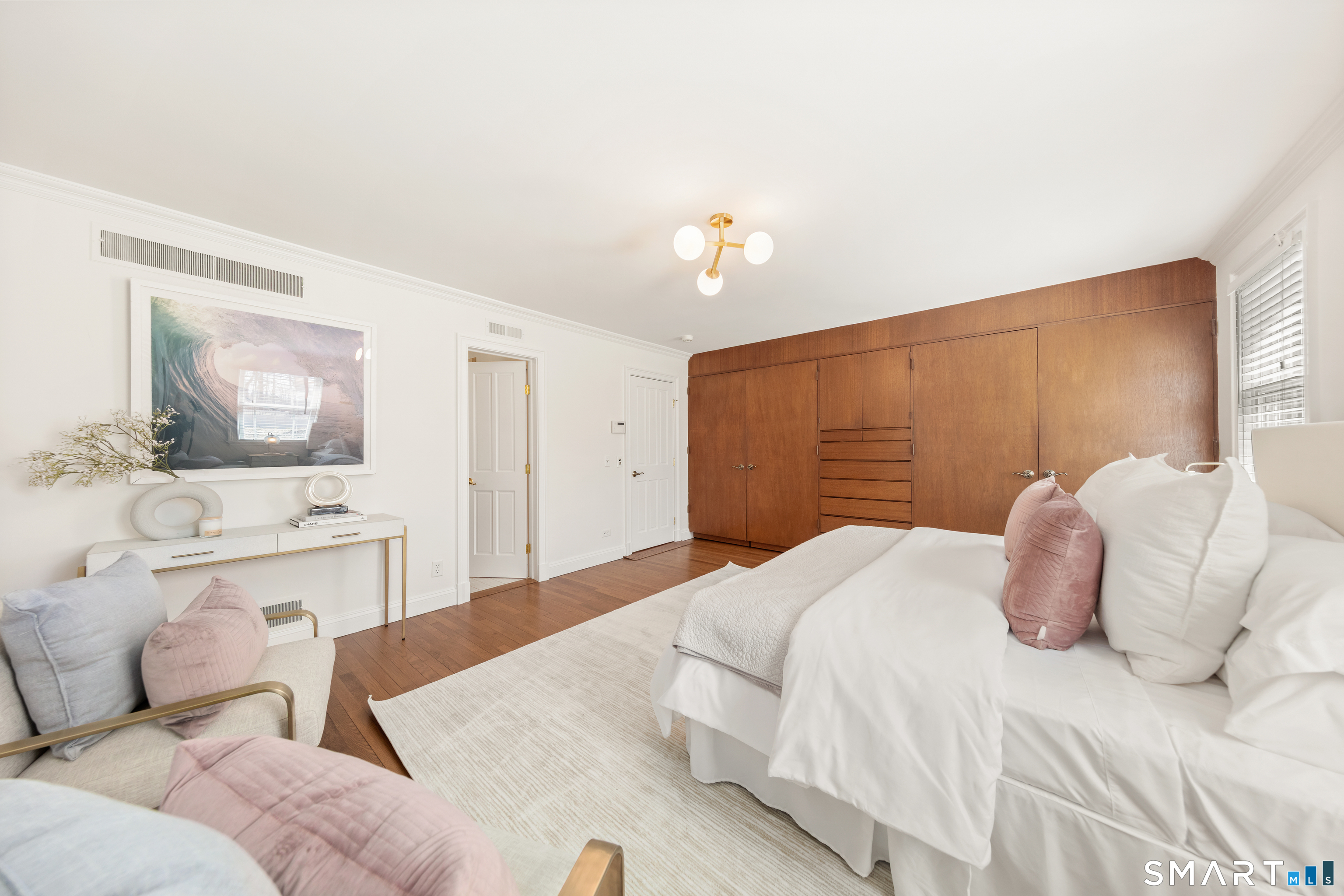 143 Palmer Hill Road Stamford, CT 06902 - Photo 20 of 40 a bedroom with a large bed and a chandelier