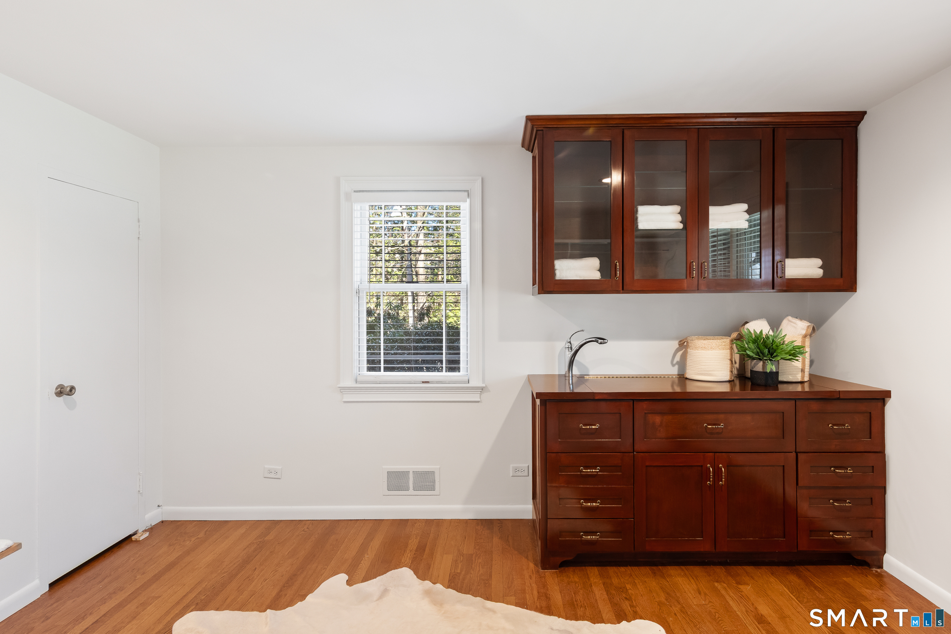 143 Palmer Hill Road Stamford, CT 06902 - Photo 27 of 40 a room with a bed and wooden floor