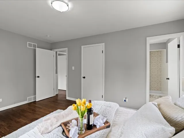 a bed sitting in a bedroom next to a window