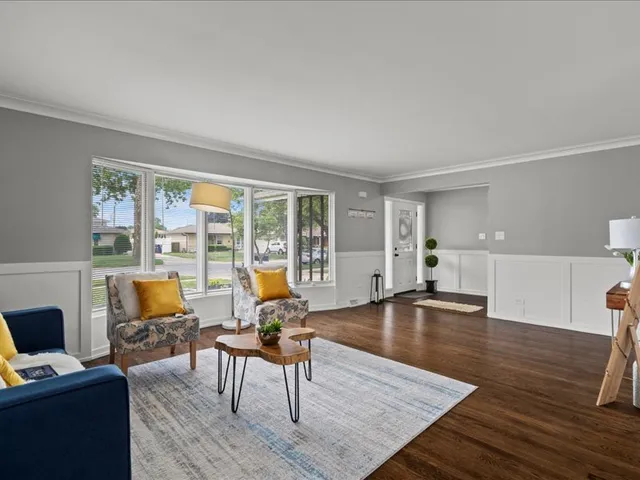a living room with furniture water view and large windows