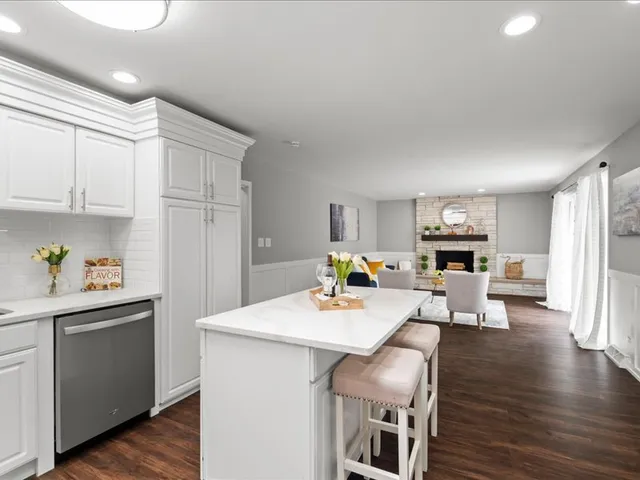 a kitchen with a table chairs microwave and cabinets