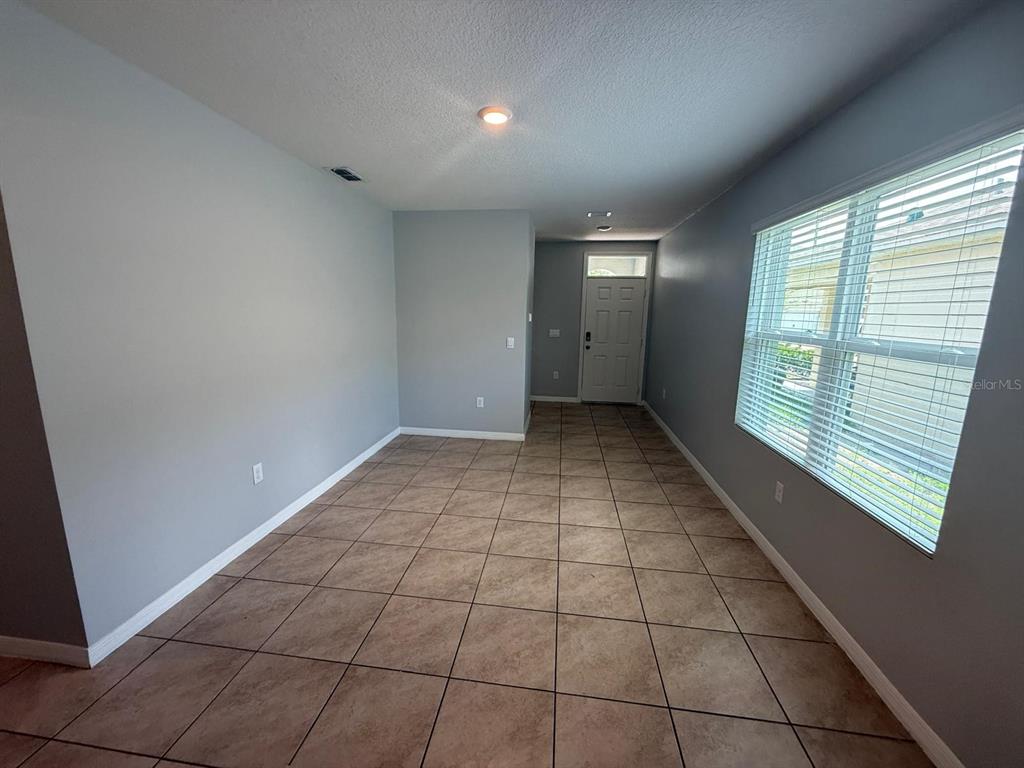 754 Chinoy Road Davenport, FL 33837 - Photo 6 of 26 a view of an empty room with a window