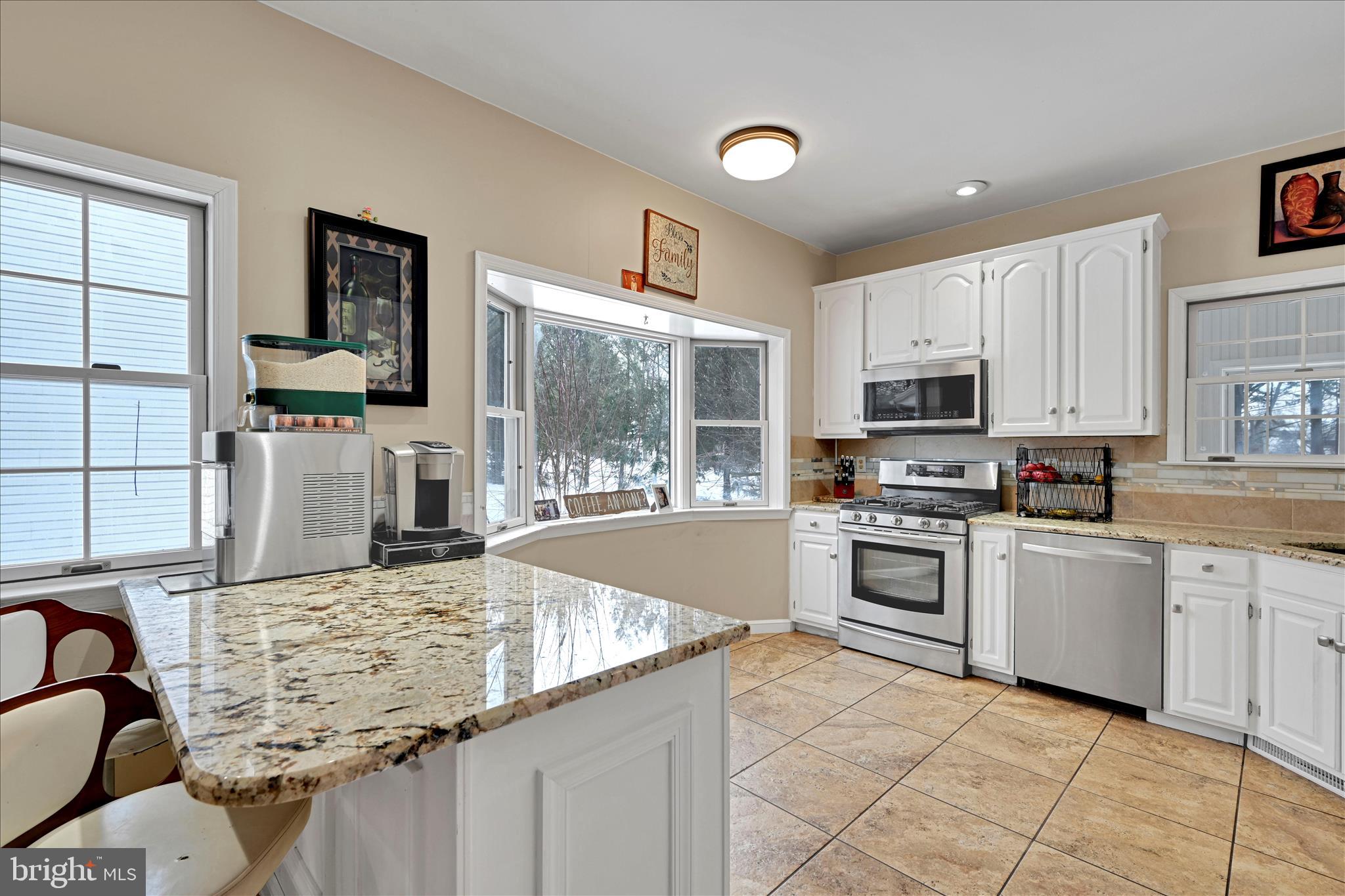 717 Brookside Lane Lebanon, PA 17042 - Photo 16 of 45 a kitchen with kitchen island granite countertop a stove sink and microwave