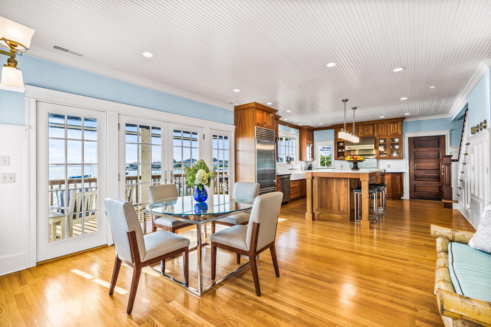 20 Bay Shore Road Hyannis, MA 02601 - Photo 15 of 42 a dining room with stainless steel appliances a dining table wooden floor a large window and kitchen view
