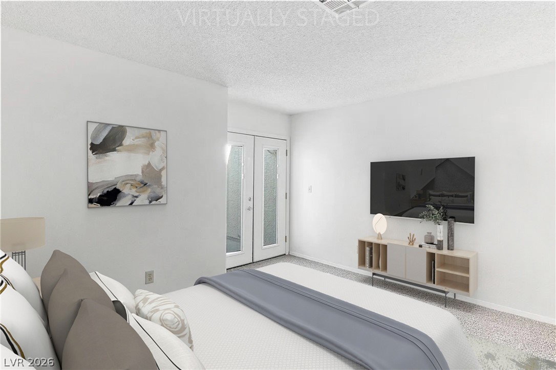 2146 High Dunes Lane Laughlin, NV 89029 - Photo 21 of 64 Virtually Staged - Primary bedroom featuring french doors, baseboards, and a textured ceiling