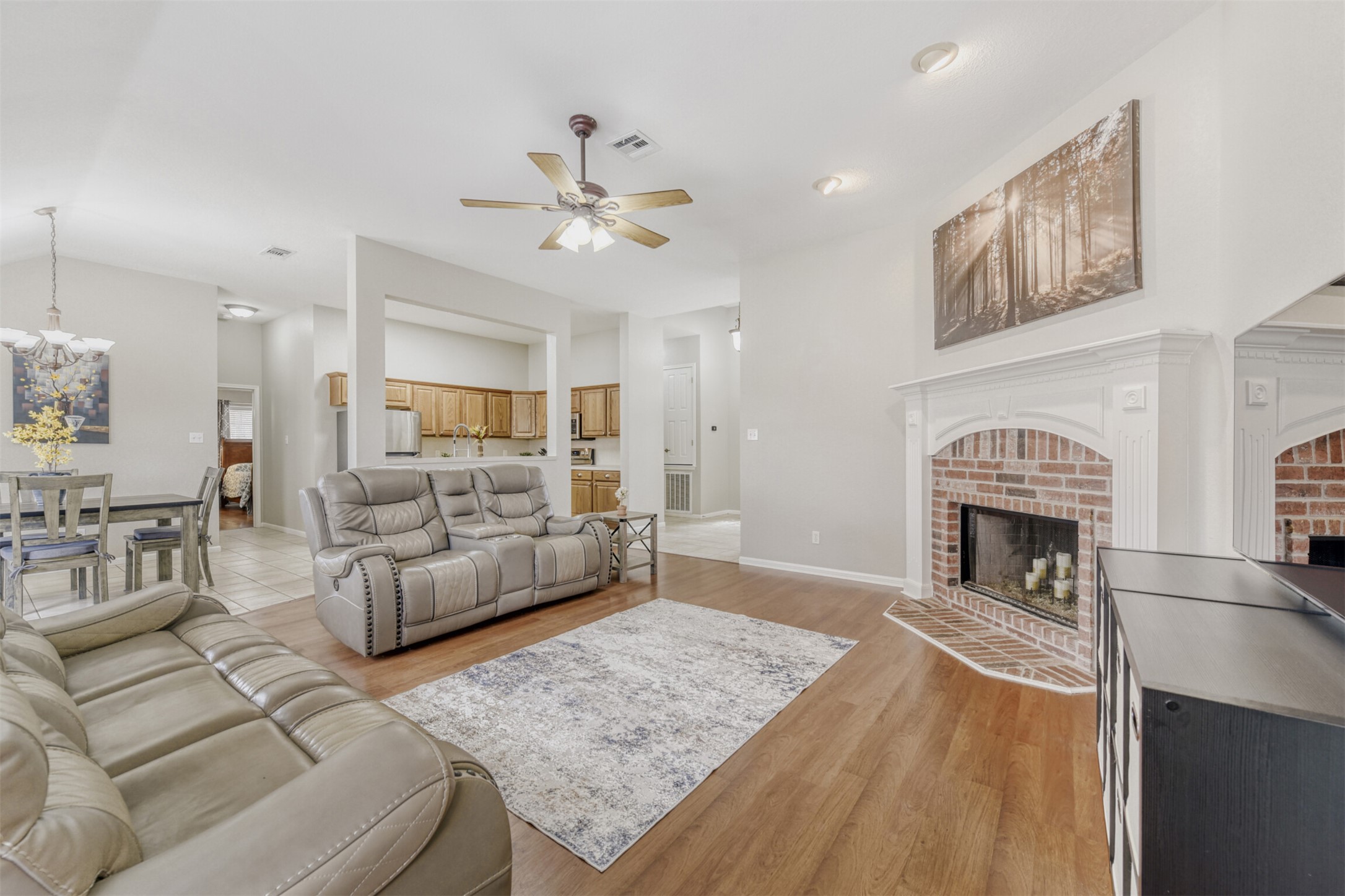 104 Spring Branch Bastrop, TX 78602 - Photo 14 of 32 Living area with light wood-style floors, ceiling fan, a fireplace, and vaulted ceiling