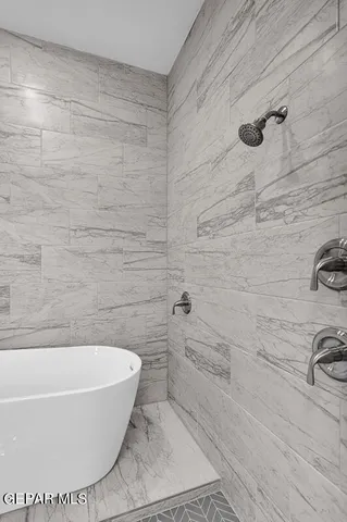 a white bath tub sitting in a bathroom