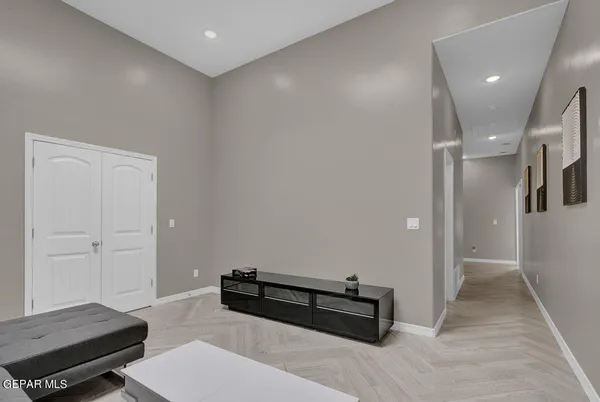 a bedroom with a bed a mirror and a window