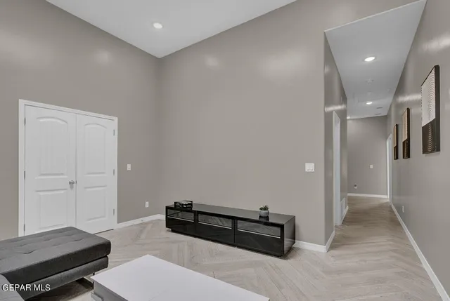 a bedroom with a bed a mirror and a window