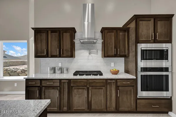 a kitchen with stainless steel appliances a stove and a refrigerator