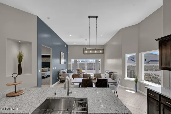 a living room with lots of furniture and a chandelier