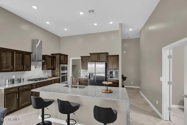 a kitchen with sink refrigerator and microwave