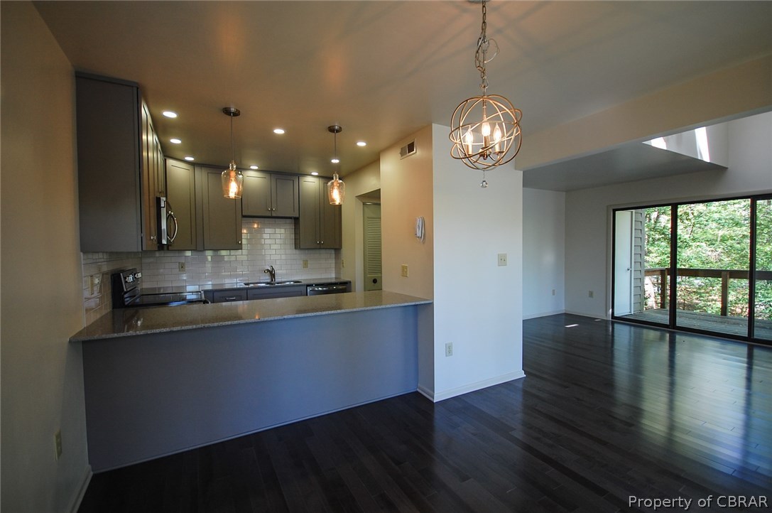 54 D Villa Ridge Drive, Unit D Hartfield, VA 23071 - Photo 7 of 34 BRAND NEW KITCHEN BOASTS GRANITE, MODERN CABINETRY & SUBWAY TILED BACKSPLASH
