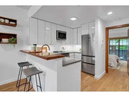 a kitchen with stainless steel appliances a sink stove and microwave