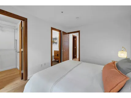 a bedroom with a bed and a large window
