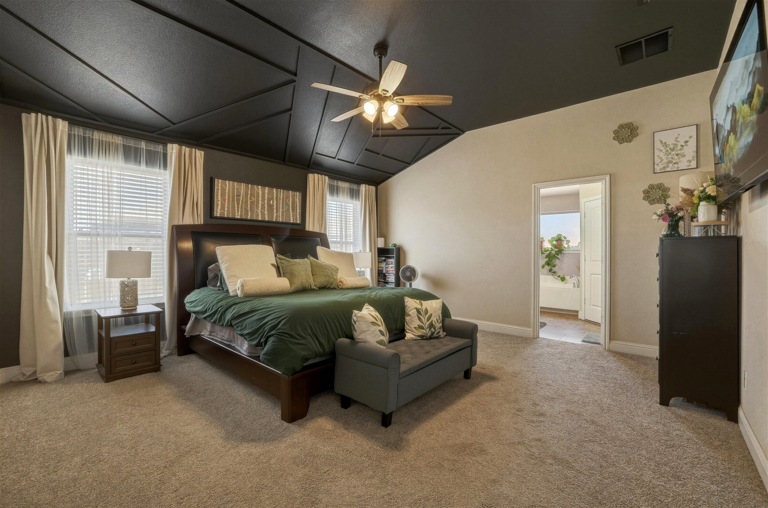8808 Rochester Avenue Lubbock, TX 79424 - Photo 11 of 27 a bedroom with a bed ceiling fan and a large window