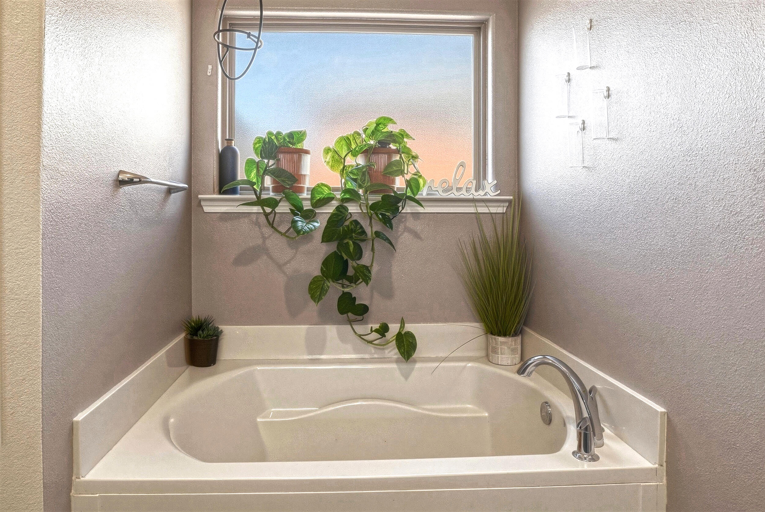 8808 Rochester Avenue Lubbock, TX 79424 - Photo 15 of 27 a white bath tub sitting in a bathroom