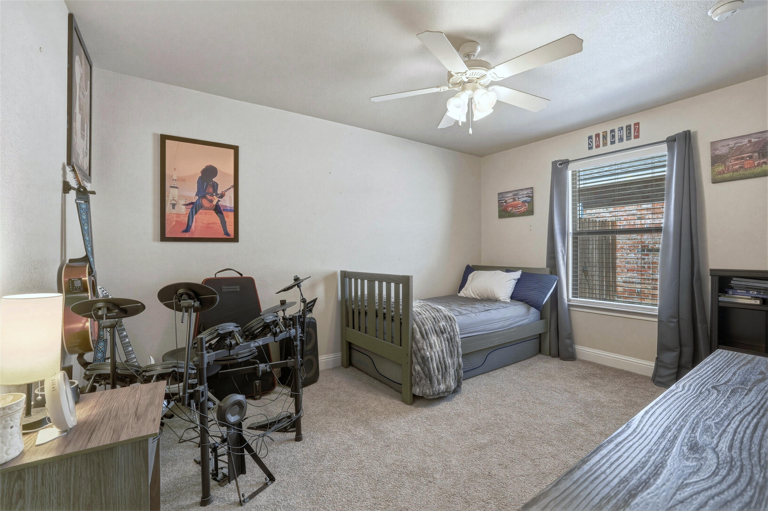 8808 Rochester Avenue Lubbock, TX 79424 - Photo 19 of 27 a bedroom with furniture and a window