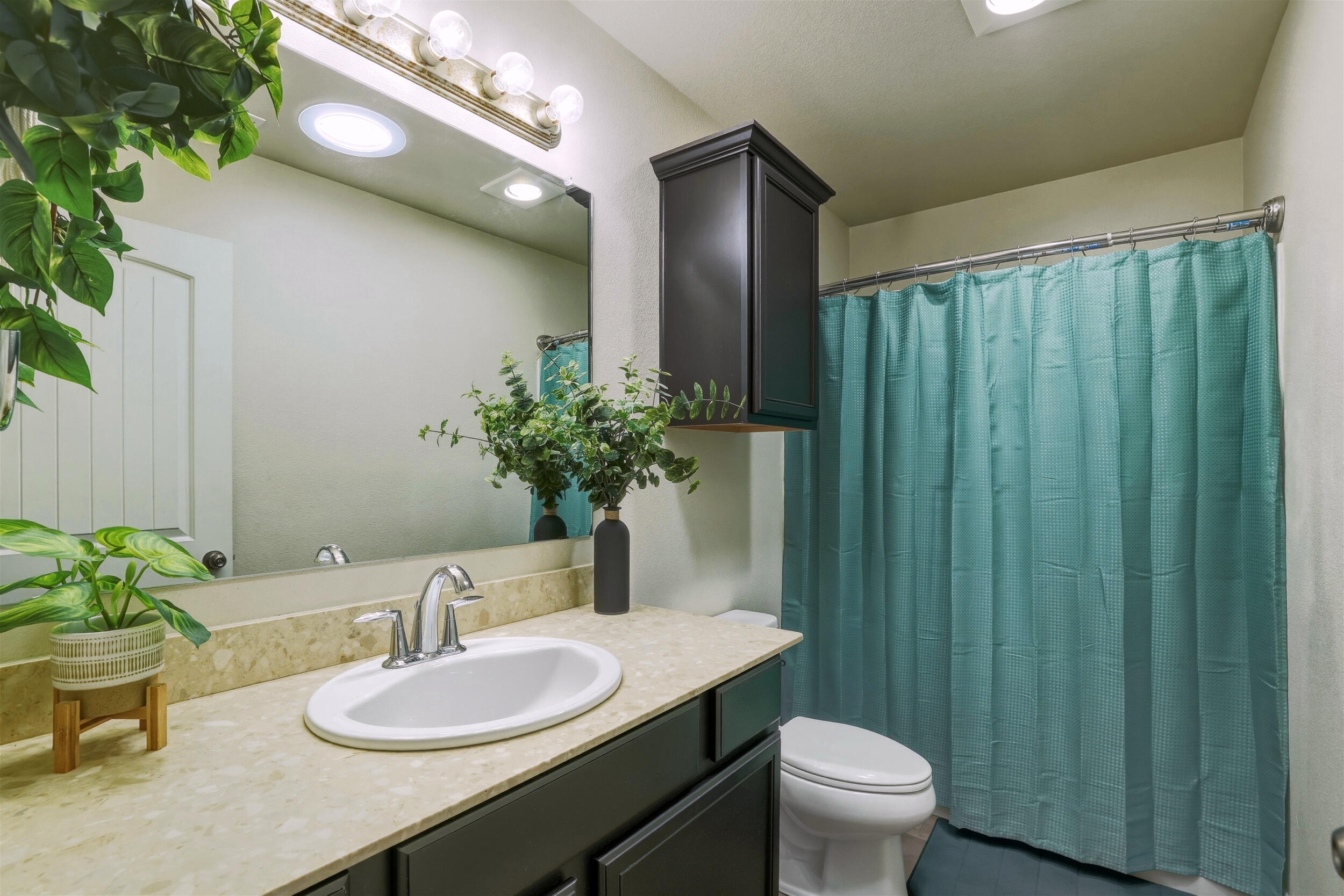 8808 Rochester Avenue Lubbock, TX 79424 - Photo 20 of 27 a bathroom with a granite countertop sink and a mirror