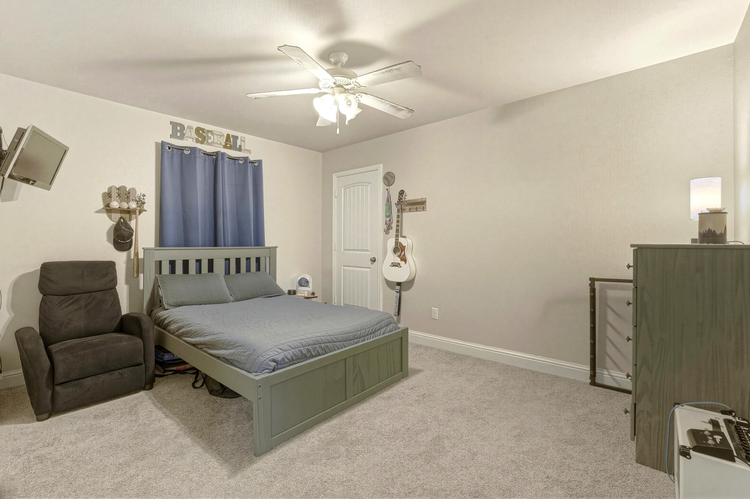 8808 Rochester Avenue Lubbock, TX 79424 - Photo 21 of 27 a living room with furniture and a chandelier