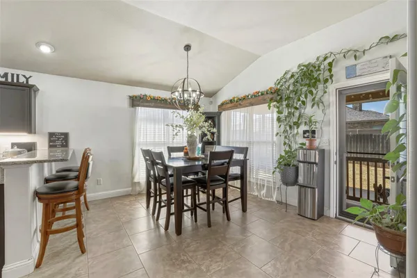 a kitchen with lots of counter top space sink dining table and chairs