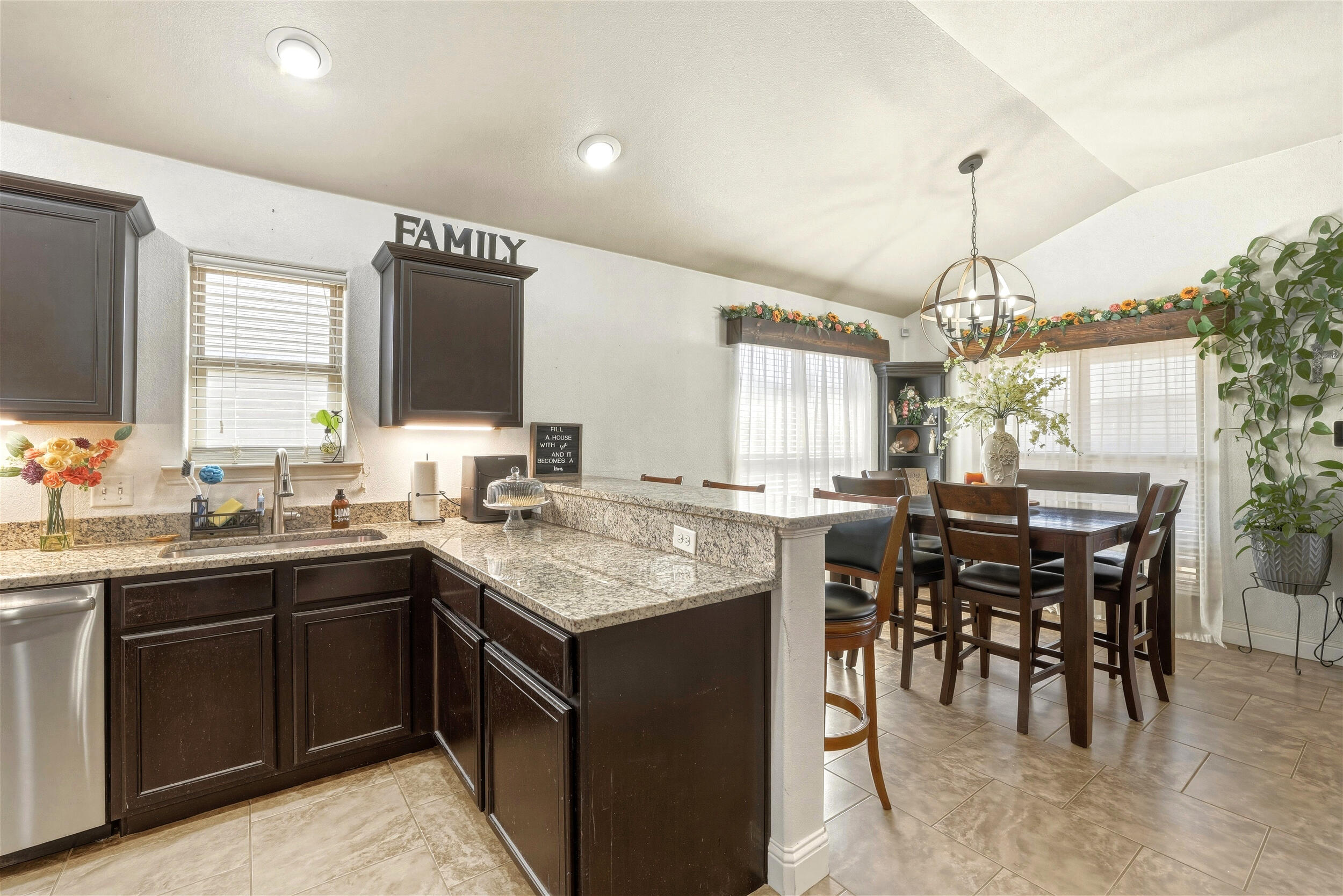 8808 Rochester Avenue Lubbock, TX 79424 - Photo 8 of 27 a kitchen with lots of counter top space sink dining table and chairs