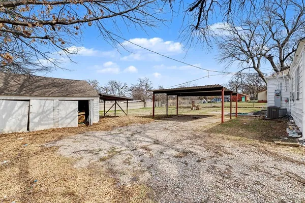 a view of a yard with a tree
