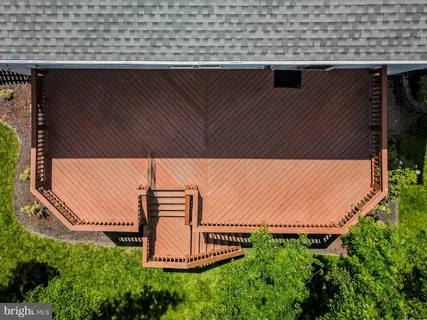 a aerial view of a house with table and chairs under an umbrella