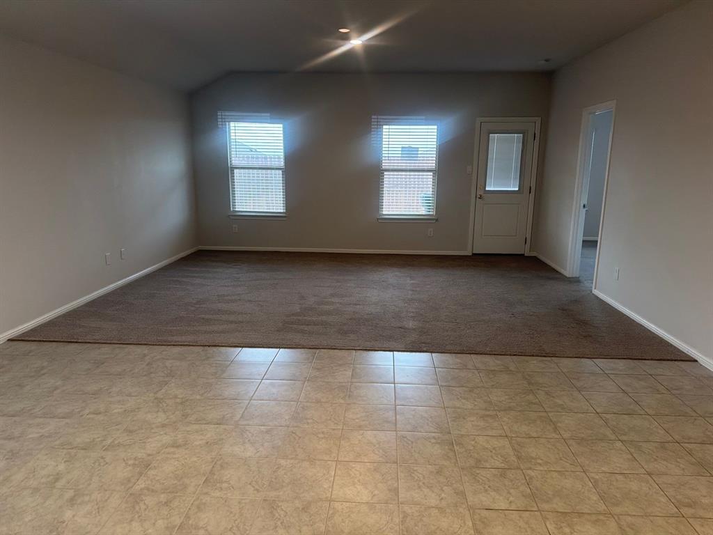 721 Durango Lane Cleburne, TX 76033 - Photo 7 of 25 an empty room with wooden floor and windows