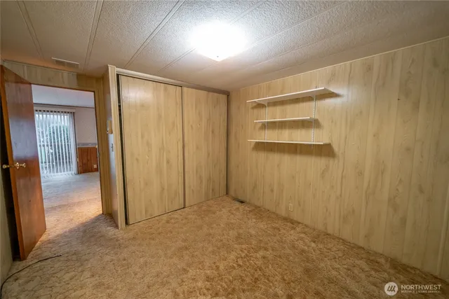 an empty room with closet area