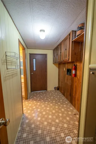 a view of hallway with wooden door
