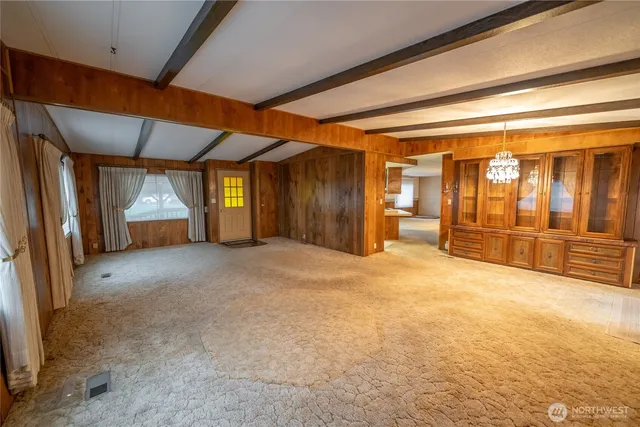 a view of empty room with wooden walls