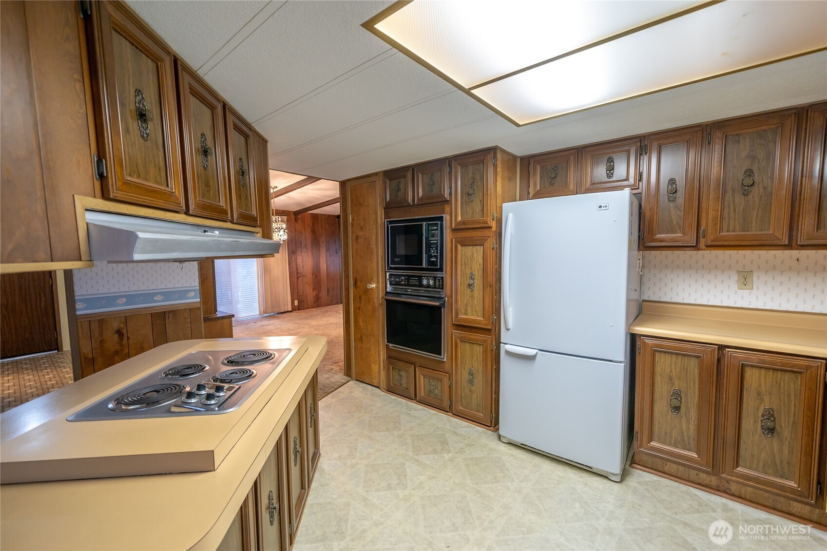 57 Clemons Road, Unit 64 Montesano, WA 98563 - Photo 9 of 35 a kitchen with a refrigerator and a stove top oven