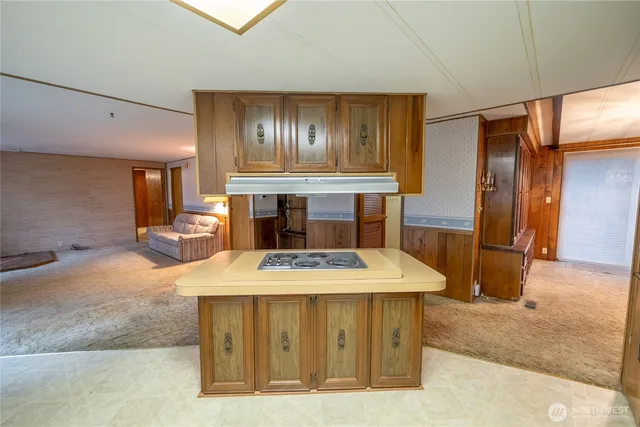 a view of kitchen with refrigerator stove and wooden cabinets