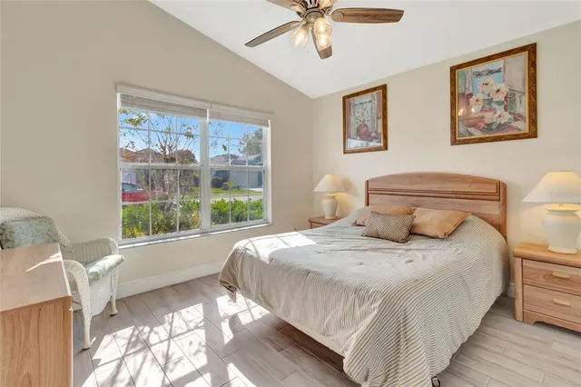 a bedroom with a large bed and a window