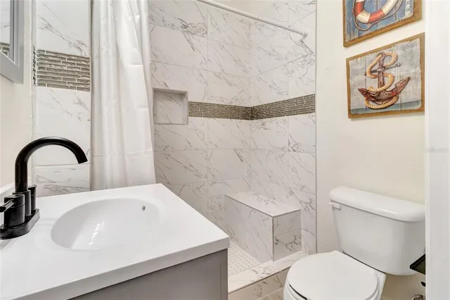 a bathroom with a sink a toilet and a bathtub