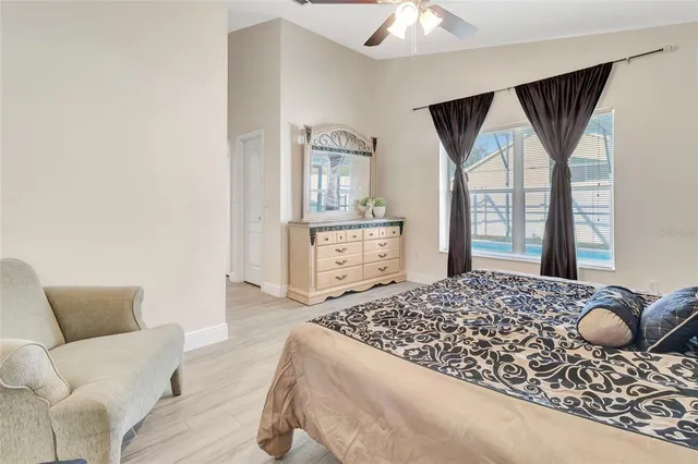 a living room with a bed and dresser