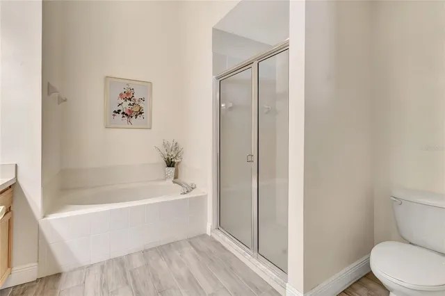 a white bath tub sitting next to a white toilet