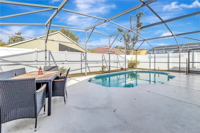 an aerial view of residential houses with outdoor space and swimming pool