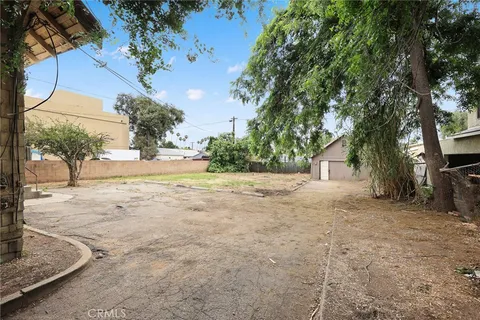 a view of a house with a tree in the background