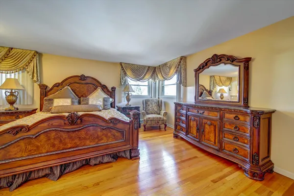a bedroom with furniture and a wooden floor